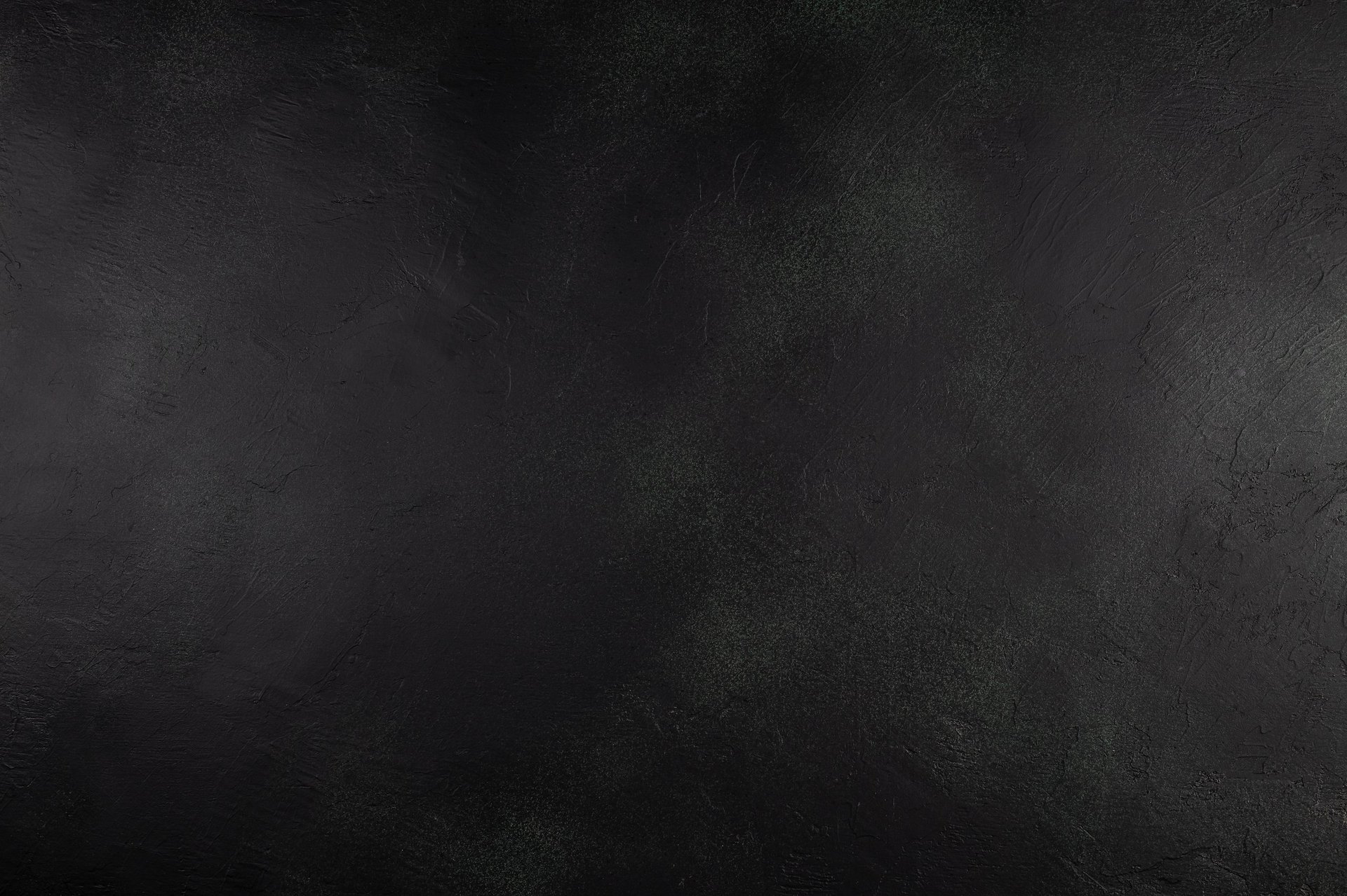 Dark black textured background with subtle rough patterns and empty copy space